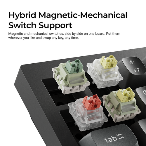 Close-up of a black mechanical keyboard showing four magnetic and mechanical switch modules inserted into the keybed, with marketing text at the top reading 'Hybrid Magnetic-Mechanical Switch Support'.